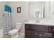 Bathroom featuring dark wood cabinetry, a framed mirror, and combined tub and shower with patterned shower curtain at 50143 Robins Nest Ln, Lancaster, SC 29720