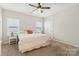 Spacious bedroom with a ceiling fan, carpet flooring, and natural light at 50143 Robins Nest Ln, Lancaster, SC 29720