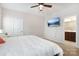 Bright bedroom featuring a ceiling fan, ensuite bathroom, and a wall-mounted television for comfortable living at 50143 Robins Nest Ln, Lancaster, SC 29720