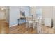 Bright dining area featuring a glass table, chandelier, and wood floors at 50143 Robins Nest Ln, Lancaster, SC 29720