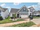 Charming home featuring manicured lawn, attractive landscaping, and a two-car garage at 50143 Robins Nest Ln, Lancaster, SC 29720
