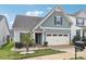 Inviting home showcasing a well-kept lawn and attractive landscaping at 50143 Robins Nest Ln, Lancaster, SC 29720