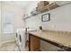 Well-organized laundry room featuring counter space, storage shelves, and a washer and dryer at 50143 Robins Nest Ln, Lancaster, SC 29720