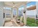Relaxing screened porch with comfortable seating, ceiling fan, and a view of the fenced backyard at 50143 Robins Nest Ln, Lancaster, SC 29720