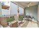 Cozy screened porch featuring a ceiling fan, comfortable seating, and a peaceful view of the fenced yard at 50143 Robins Nest Ln, Lancaster, SC 29720