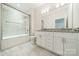 Modern bathroom featuring a dual-sink vanity and a combined shower and tub at 5125 Isaac Dr, Charlotte, NC 28216