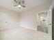 A spacious, carpeted bedroom with a ceiling fan and an open doorway at 5125 Isaac Dr, Charlotte, NC 28216