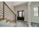 Bright foyer showcases wood stairs with metal railing and a modern front door with decorative glass at 5125 Isaac Dr, Charlotte, NC 28216