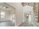 Spacious hallway leads to various rooms, showcasing modern gray flooring and neutral wall colors at 5125 Isaac Dr, Charlotte, NC 28216