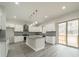 Open kitchen features white cabinets, granite countertops, stainless steel appliances, and gray brick backsplash at 5125 Isaac Dr, Charlotte, NC 28216