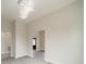 Open-concept living room featuring stylish gray flooring, neutral walls, and a modern chandelier at 5125 Isaac Dr, Charlotte, NC 28216