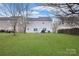 Residential home's backyard featuring green lawn and mature trees at 514 Galesburg Dr, Monroe, NC 28110