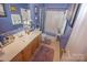 Bathroom featuring a well-lit vanity and a shower-tub combination at 514 Galesburg Dr, Monroe, NC 28110