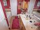 Bathroom featuring double sinks, red walls, tile floors, and a tub at 514 Galesburg Dr, Monroe, NC 28110