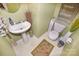 Cozy powder room with pedestal sink and tasteful decor at 514 Galesburg Dr, Monroe, NC 28110