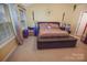 Bedroom with a leather base bed frame, large windows, and yellow walls at 514 Galesburg Dr, Monroe, NC 28110