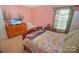 Bedroom featuring a floral-patterned bed and a dresser with TV at 514 Galesburg Dr, Monroe, NC 28110