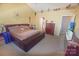 Bedroom with a leather base bed frame, large windows, and yellow walls at 514 Galesburg Dr, Monroe, NC 28110