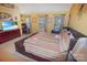 Bedroom with a leather base bed frame, large windows, and yellow walls at 514 Galesburg Dr, Monroe, NC 28110
