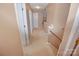 Hallway featuring carpeted floors, neutral walls, and multiple doors at 514 Galesburg Dr, Monroe, NC 28110