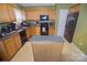 Functional kitchen with wooden cabinets and an island providing extra counter space at 514 Galesburg Dr, Monroe, NC 28110