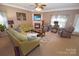 Comfortable living space with a cozy fireplace, ceiling fan, and plush seating, designed for relaxation and gatherings at 514 Galesburg Dr, Monroe, NC 28110