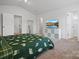Bright bedroom with carpet, a window with curtains, storage, and a comfortable bed featuring multiple doors, creating a spacious feel at 709 Daniel Ln, Richburg, SC 29729