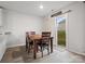 Bright dining area features a wood table, four chairs, and sliding door to backyard, creating a cozy and inviting atmosphere at 709 Daniel Ln, Richburg, SC 29729