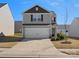 Two-story home with gray siding, a two-car garage, and a well-maintained lawn at 709 Daniel Ln, Richburg, SC 29729