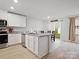 Bright kitchen featuring white cabinets, granite countertops, and a stainless steel dishwasher at 709 Daniel Ln, Richburg, SC 29729