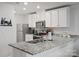 Modern kitchen features granite countertops, stainless steel appliances, white cabinets, and ample counter space for cooking at 709 Daniel Ln, Richburg, SC 29729