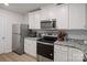 Well-equipped kitchen with stainless steel appliances, granite counters, white cabinetry, and modern fixtures for easy meal preparation at 709 Daniel Ln, Richburg, SC 29729