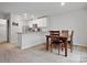 Open-concept kitchen and dining area with white cabinets, stainless steel appliances, and a stylish table with four chairs at 709 Daniel Ln, Richburg, SC 29729