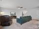 Open-concept living space with a blue sectional, a ceiling fan, and a view of the staircase at 709 Daniel Ln, Richburg, SC 29729