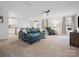 Spacious living room with a plush blue sectional, neutral carpet, and abundant natural light at 709 Daniel Ln, Richburg, SC 29729
