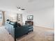 Cozy living room featuring a comfortable blue sofa, entertainment center, and a ceiling fan at 709 Daniel Ln, Richburg, SC 29729