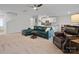 Bright living room with a blue sofa, kitchen in the background, and a cozy seating area at 709 Daniel Ln, Richburg, SC 29729