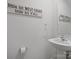 A stylish half-bathroom with decorative signage and a pedestal sink at 709 Daniel Ln, Richburg, SC 29729