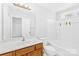 Bright bathroom showcasing a vanity, large mirror, toilet, and a combined tub and shower at 8263 Carob Tree Ln, Charlotte, NC 28215