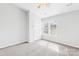 Inviting bedroom with a ceiling fan and large window providing natural light and views at 8263 Carob Tree Ln, Charlotte, NC 28215