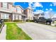 Street view of townhome with green lawn, driveway, and space for two parked cars at 8263 Carob Tree Ln, Charlotte, NC 28215