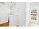 Inviting hallway with stairway, closet space, and natural light from a window at 8263 Carob Tree Ln, Charlotte, NC 28215