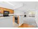 Open kitchen view with black appliances and natural wood cabinets flowing into the living space at 8263 Carob Tree Ln, Charlotte, NC 28215