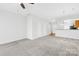 Open-concept living room with access to the kitchen, stairs, and front door, perfect for modern living at 8263 Carob Tree Ln, Charlotte, NC 28215