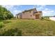 Backyard with grass and a back door with a patio at 8309 Knapp Ct, Locust, NC 28097