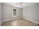 Bright bedroom with window view, light hardwood floors and ceiling fan at 8309 Knapp Ct, Locust, NC 28097