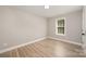 Bright bedroom with window view and trim, light hardwood floors, recessed lighting and a white trim at 8309 Knapp Ct, Locust, NC 28097