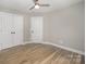 Bright bedroom features hardwood floors, modern ceiling fan, and ample closet space at 8309 Knapp Ct, Locust, NC 28097