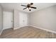 Clean bedroom boasts hardwood floors, closet space, and modern ceiling fan at 8309 Knapp Ct, Locust, NC 28097