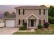 Charming two-story home with neutral siding, black shutters, and a well-manicured front yard at 8309 Knapp Ct, Locust, NC 28097